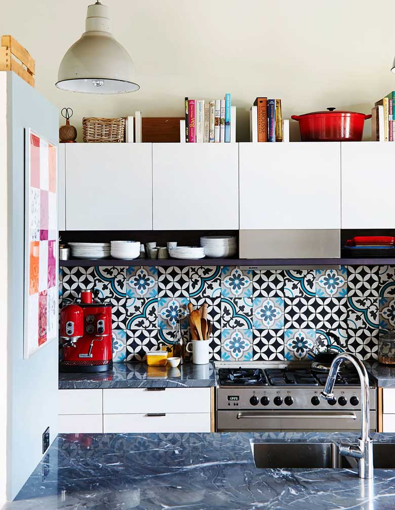 Decorate above kitchen cabinets with cookbooks