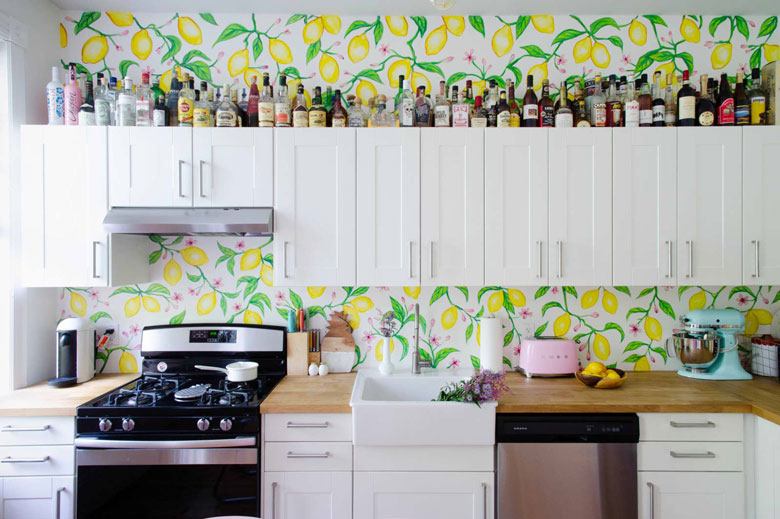 Decorate above kitchen cabinets with glassware and bottles