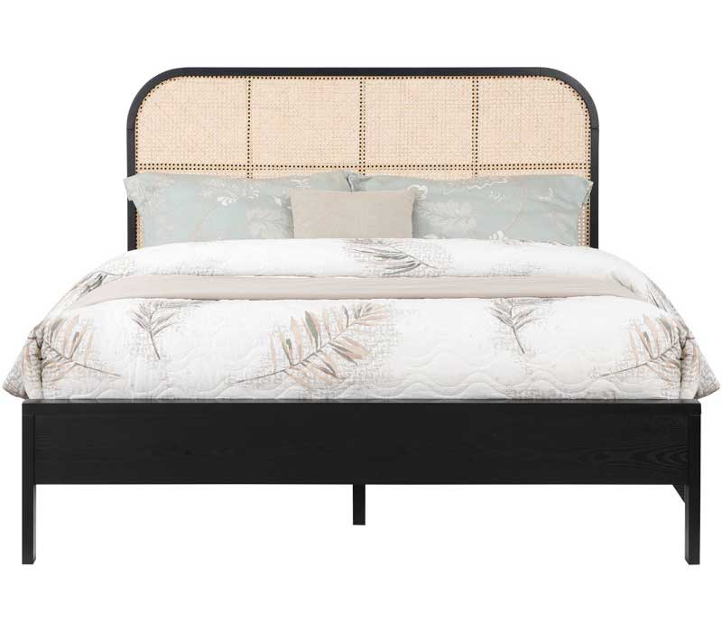 Cane bed with black frame for a boho bedroom