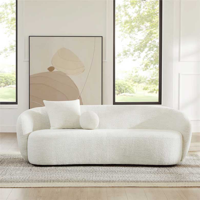 Modern 3 seater curved sofa with two pillows included, perfect for a contemporary living room