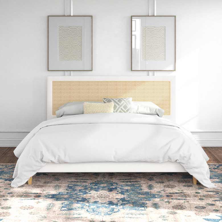 White cane bed for sale with panel headboard, low sideboards, and tapered feet